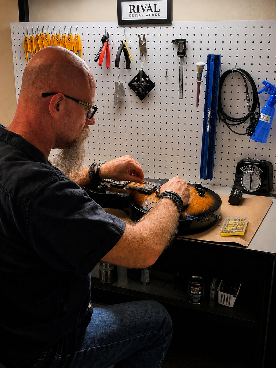 Ryan Andreasen working on a guitar at the Rival Guitar Works bench