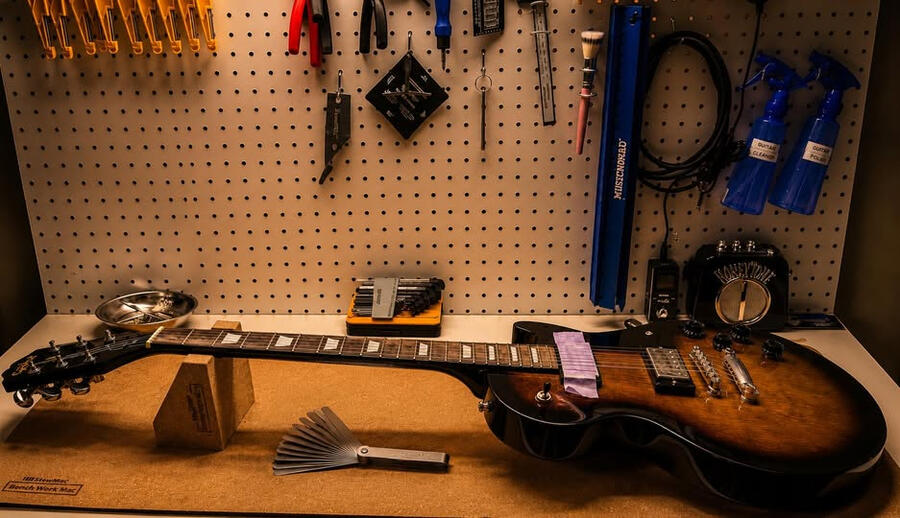 A Les Paul-style guitar on the Rival Guitar Works bench